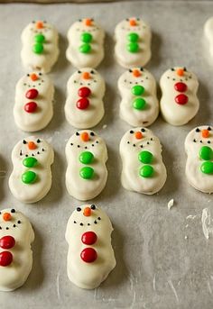 there are many snowmen on the baking sheet