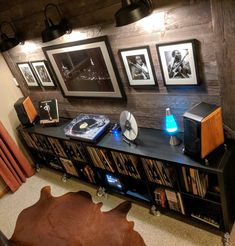 an entertainment center with speakers, record players and pictures on the wall