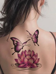 the back of a woman's neck with butterflies on it and a lotus flower