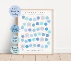 a blue and white poster with the words reward chart on it in front of a wooden frame