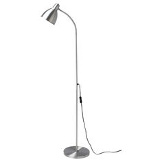 a white floor lamp with a silver base and a black light bulb on the side