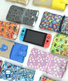 nintendo wii cases lined up next to each other on a white surface with the gameboy in between them