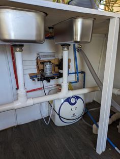 the pipes are connected to the water heater under the sink in the kitchen area