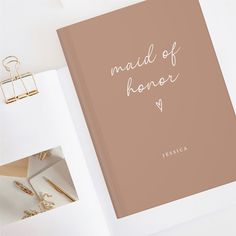 an open book with the words maid of honor written on it next to other items