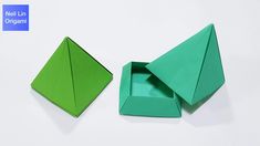 two green origami boxes sitting next to each other