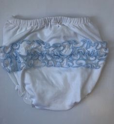 a cloth diaper with blue and white swirls on the front, sitting on a white surface