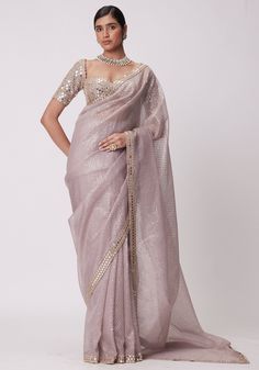 Elevate your style with our exquisite pink organza saree with a mirror blouse set. This stunning ensemble features a beautiful pink organza saree adorned with intricate hand-cut mirror embroidery. The saree is complemented by an elbow length sleeve blouse, also embellished with delicate mirror embroidery. Step into any occasion with confidence, as this saree set effortlessly combines elegance and sophistication. Perfect for Mehendi, sangeet ceremonies, or as a wedding guest. Composition : Saree - Organza, Blouse - Georgette Care: Dry Clean Only and Vacuum Storage This product can be customized for sleeves, length and colour Delivery : 6-8 weeks as the product is hand crafted. Check Size Guide or choose MySize for free customisation (All Sizes above XL can be made at 15% additional cost) Fo Pink Organza Saree, Vine Embroidery, Ash Pink, Sabyasachi Sarees, Full Sleeve Blouse, Organza Blouse, Indian Wedding Wear, Embroidered Organza, Dress Chiffon