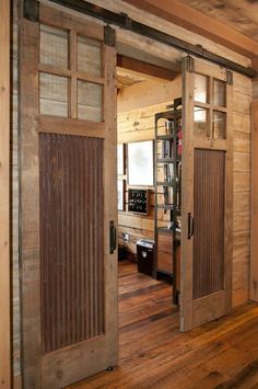 an open door leading to a living room with wood floors