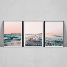 three framed photographs of ocean waves and rocks