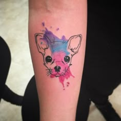 a small chihuahua tattoo on the left forearm and leg, with watercolor splashs