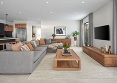 a living room filled with furniture and a flat screen tv mounted on the wall above it