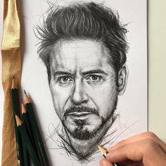 a pencil drawing of a man's face with his hair pulled back and beard