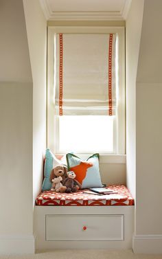 a stuffed animal sitting on top of a white bench in front of a window sill