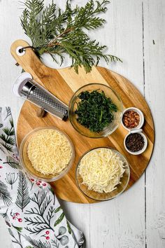 the ingredients to make this dish are displayed on a cutting board, including parmesan cheese and herbs