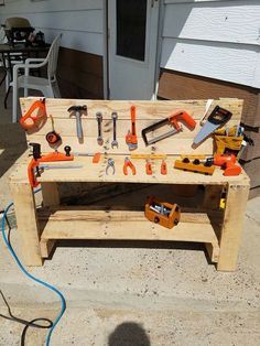 a wooden work bench with tools on it