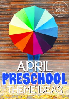 a person holding an umbrella over their head with the words, april preschool theme ideas