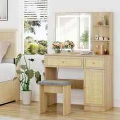 a bedroom scene with focus on the vanity and bed, along with potted plants