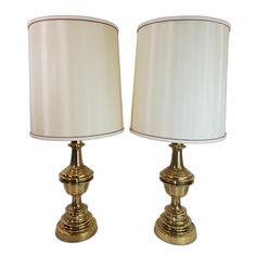 pair of brass table lamps with white shades