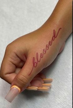 a woman's hand with the word beware written in red ink on it