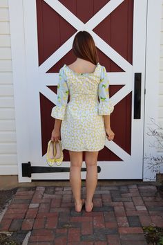 Perfect for the spring, perfect for the summer and the good times never looked so good! Our Sweet Caroline Dress combines a yellow daisy print with a juicy light blue lemon print in this flirty, fun lightweight dress. Made of airy cotton and fully lined it has a short ruffle at the neck and ruffled sleeves. Pair it with flats or heels, this versatile dress will take you just about anywhere! 100% Cotton, sewn in the U.S.A. Made in USA100% CottonFully LinedAbove the KneeBack Zipper3/4 Sleve Spring Daisy Print Vacation Dress, Spring Daisy Print Mini Dress For Vacation, Spring Daisy Print Mini Dress For Day Out, Summer Lemon Print Sundress For Vacation, Summer Sundress With Lemon Print, Spring Mini Dress With Daisy Print For Day Out, Summer Sundress With Lemon Print For Vacation, Summer Style Sundress With Lemon Print For Vacation, Summer Daisy Print Mini Dress For Brunch