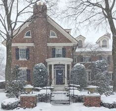 a large brick house covered in snow