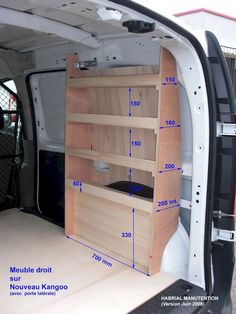 the back end of a van with shelves in it and measurements for the cargo area