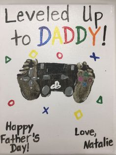 a sign that reads, leveled up to daddy happy father's day with two slotty hands holding a video game controller