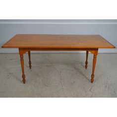 a wooden table sitting on top of a white floor