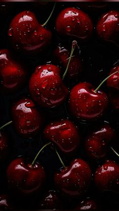 some cherries with water droplets on them