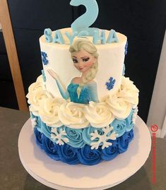 a frozen princess birthday cake with blue and white frosting