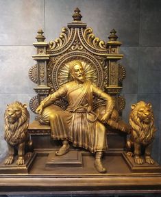 a golden statue sitting on top of a wooden table