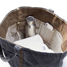 This take-anywhere travel set is crafted from a durable canvas that has been specially cured with a wax coating to age beautifully over time. Like high-quality leather, the waxed canvas looks and feels better the more you use it, and scratches and scuffs only add to its personality. Perfect for daily commuting or weekends away, the open tote features a hanging interior pocket to keep your essentials organized and the pouch features a water-resistant nylon lining. Add an embroidered monogram to t Travel Tech Organizer, Waxed Canvas Tote Bag, Tote Design, Embroidered Monogram, Gifts For Colleagues, Travel Set, Aging Beautifully, Branded Gifts, Monogram Styles