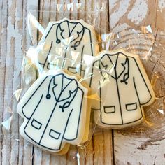 three decorated cookies in the shape of jackets