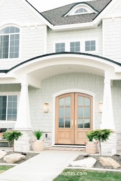 a white house with two large doors and windows