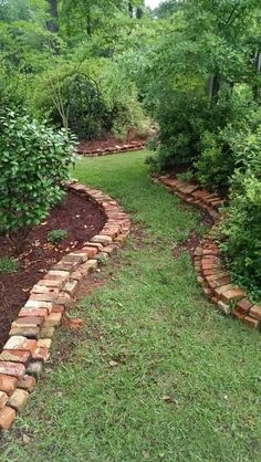 a brick path in the middle of a garden