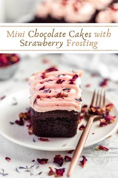 a chocolate cake with strawberry frosting on a plate next to a fork and cupcakes