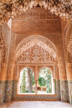 an intricately decorated archway in the middle of a building with lots of stone work on it