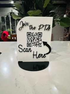 a qr code sign sitting on top of a table