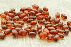 some orange glass beads are on a tablecloth and there is no image in it