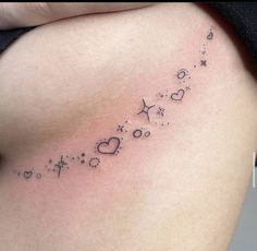 a woman's stomach with the word love written in small stars and hearts on it