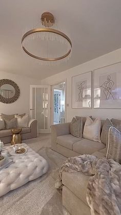 a living room filled with furniture and a chandelier