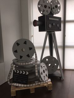 a film projector sitting on top of a wooden pallet in front of a window