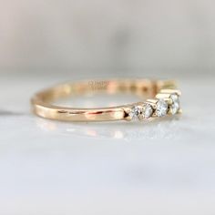 a gold ring with three diamonds on it