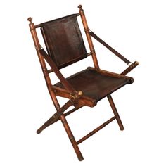 a brown leather folding chair with wooden legs and arm rests on an isolated white background