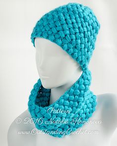 a crocheted hat and scarf on a mannequin's headpiece