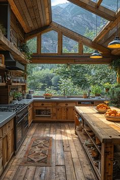 a kitchen with wooden floors and an open roof area that overlooks the mountain range