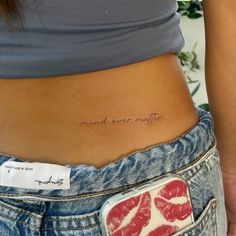 a woman's stomach with a small tattoo on it