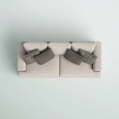 an overhead view of two couches with pillows on them, one facing each other