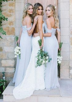 three bridesmaids standing in front of a door with their back to the camera