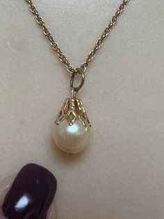 Classic genuine single pearl drop dangling from an 18" genuine 14k gold chain. Pearl is about 5-6mm round in lovely candlelit luminous cream color.   No flaws of any kind.   At the top of the pearl is a genuine 14k gold cap.   I am not certain however about the round jump ring attaching the pearl to the chain.   This might need to be replaced. Chain is a very delicate rope with spring ring clasp closure. Perfect for a bride who prefers a delicate piece at the neckline. And if you are a grandma with a granddaughter for whom you are curating a collection, this is a piece you should include. Fine Pearl Jewelry, Gold Cap, Single Pearl, Gold Caps, Wedding Jewellery Necklace, Pearl Drop, Wedding Necklace, Spring Rings, Pearl Jewelry